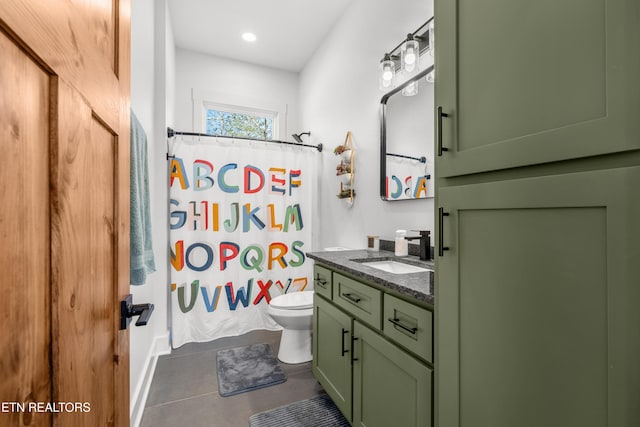 bathroom featuring tile patterned floors, vanity, toilet, and walk in shower