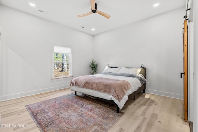 bedroom with ceiling fan and light hardwood / wood-style floors