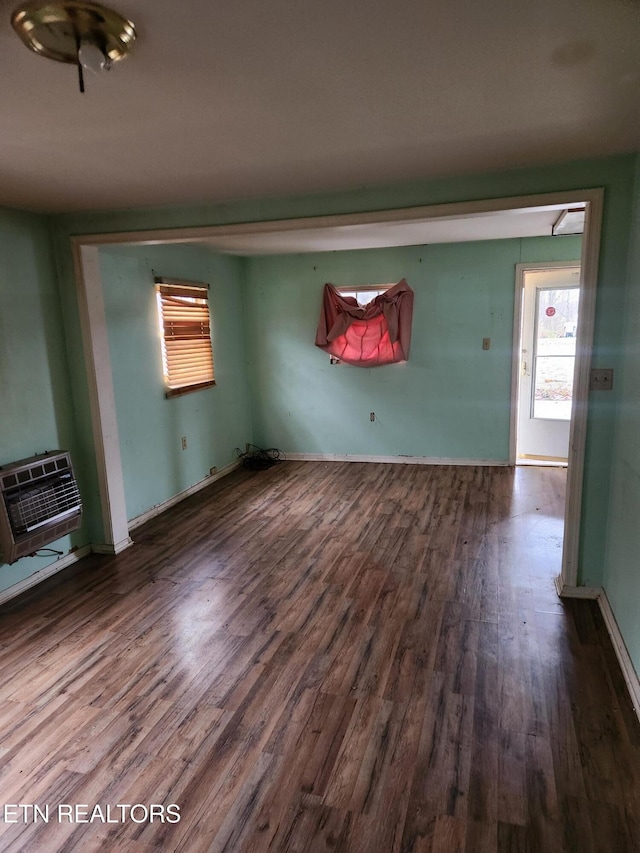 interior space featuring a wall unit AC and dark wood-type flooring