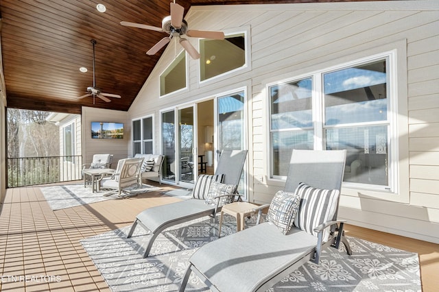 sunroom featuring ceiling fan, lofted ceiling, and wooden ceiling