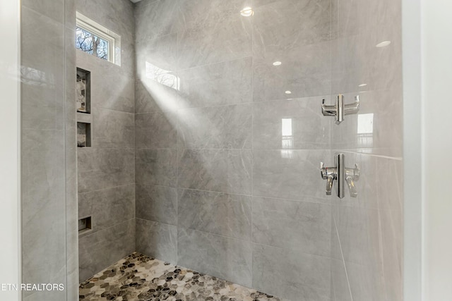 bathroom with tiled shower