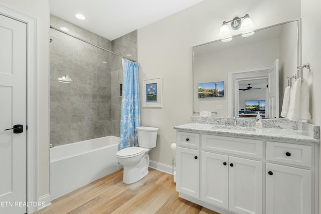 full bathroom featuring shower / tub combo, vanity, ceiling fan, hardwood / wood-style floors, and toilet