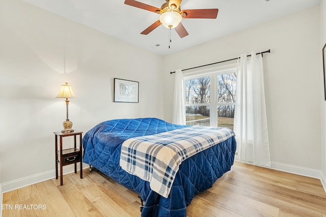 bedroom with ceiling fan and hardwood / wood-style flooring