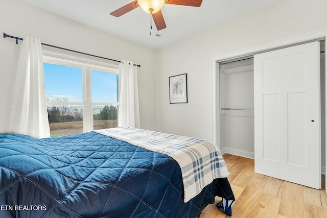 bedroom with ceiling fan, a closet, and hardwood / wood-style floors