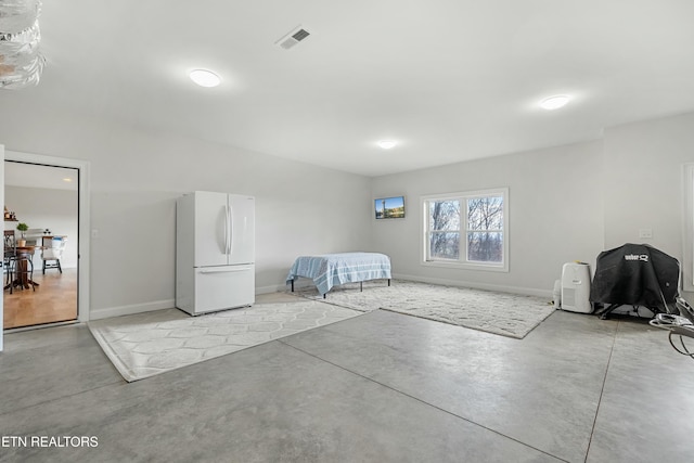 bedroom featuring white refrigerator