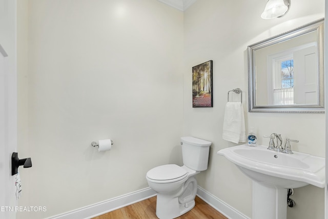 bathroom featuring wood-type flooring and toilet