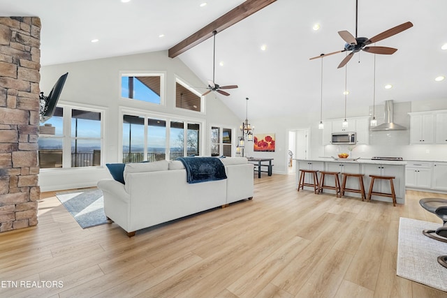 living room featuring beamed ceiling, high vaulted ceiling, light hardwood / wood-style flooring, and ceiling fan