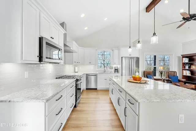 kitchen with white cabinets, appliances with stainless steel finishes, and a center island