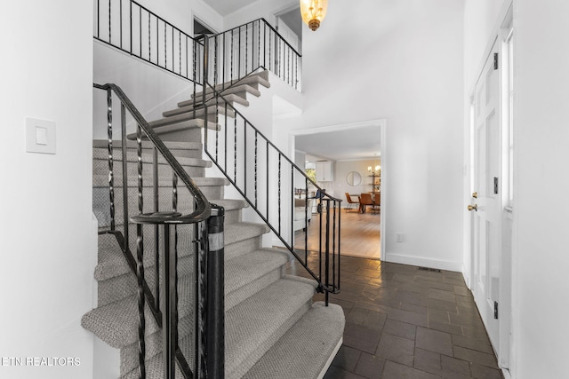 stairs featuring a towering ceiling