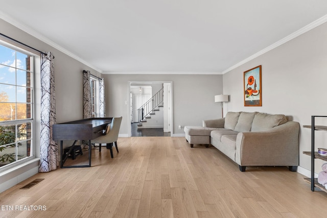 living room featuring light hardwood / wood-style flooring and ornamental molding