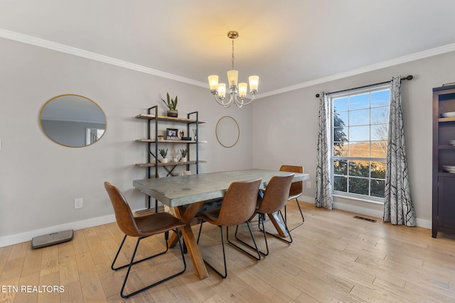 dining room with light hardwood / wood-style floors, an inviting chandelier, plenty of natural light, and ornamental molding