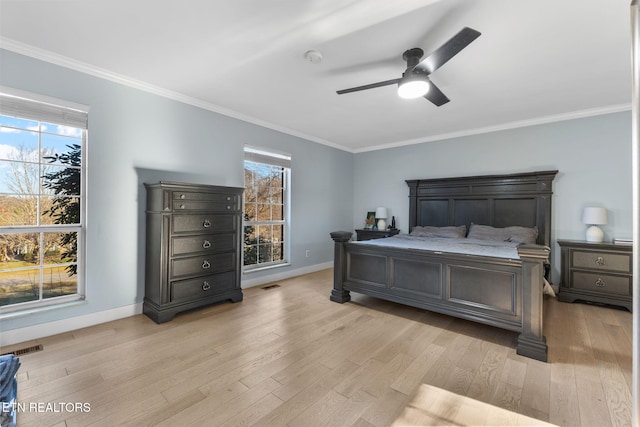 bedroom with ceiling fan, crown molding, and light hardwood / wood-style flooring