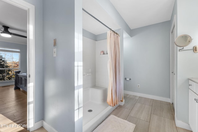 bathroom featuring curtained shower and ceiling fan