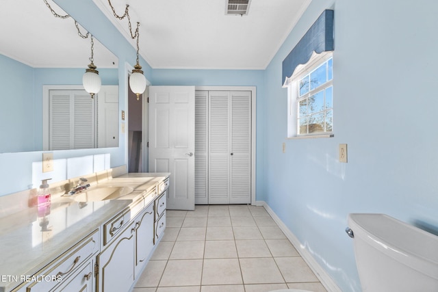 bathroom featuring tile patterned flooring, vanity, and toilet