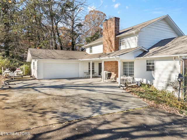 back of house featuring a garage