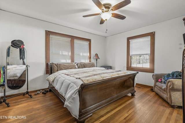 bedroom featuring ceiling fan, baseboards, and hardwood / wood-style flooring