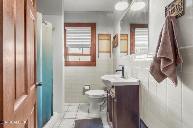 bathroom featuring toilet, a shower stall, vanity, and tile patterned floors