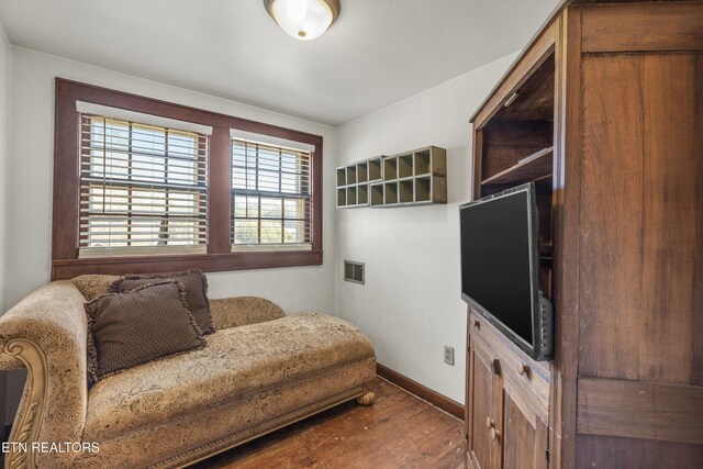 sitting room featuring visible vents, baseboards, and wood finished floors