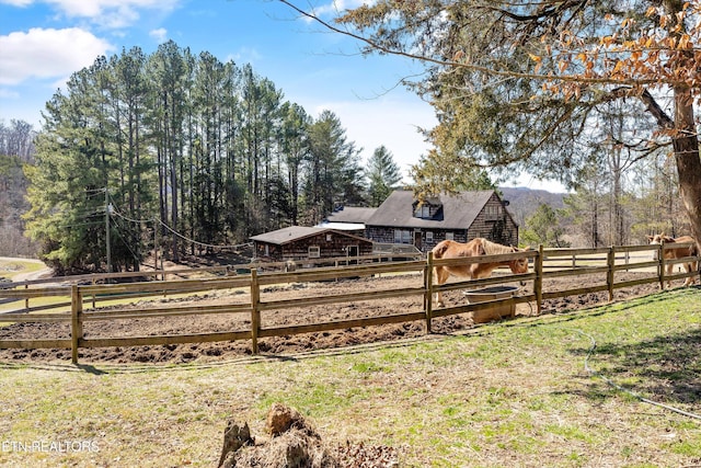 view of yard featuring fence and a rural view