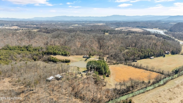 drone / aerial view featuring a rural view, a mountain view, and a view of trees