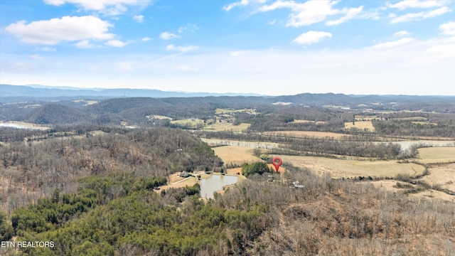 drone / aerial view with a rural view, a wooded view, and a mountain view