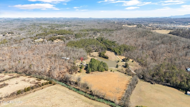 birds eye view of property with a forest view