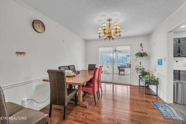 dining area with ceiling fan with notable chandelier, wood-type flooring, a textured ceiling, and ornamental molding