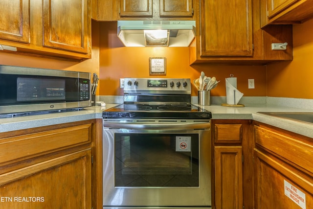 kitchen featuring appliances with stainless steel finishes and extractor fan