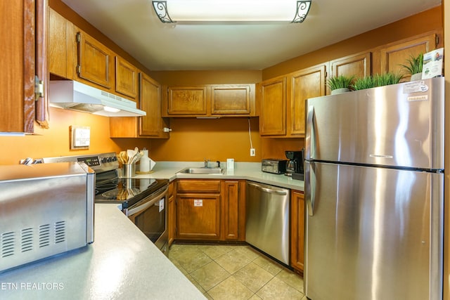 kitchen with sink, stainless steel appliances, and light tile patterned floors