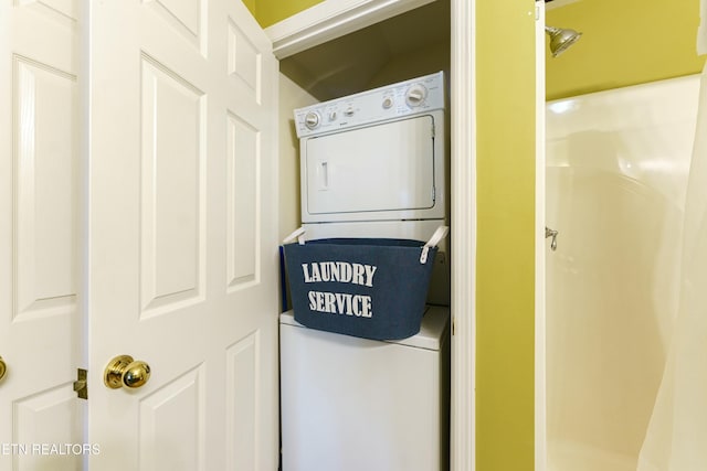 clothes washing area with stacked washer and clothes dryer