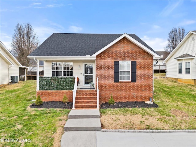 bungalow-style home with cooling unit and a front yard