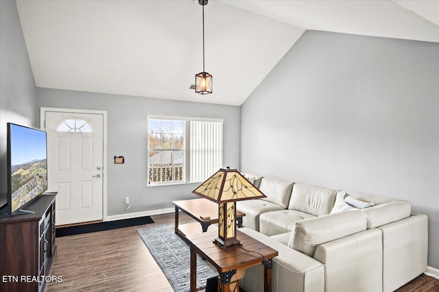 living room with dark hardwood / wood-style floors and vaulted ceiling