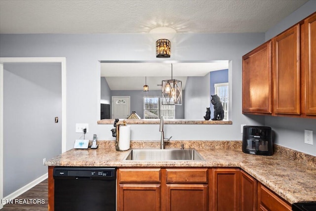 kitchen with sink, dark hardwood / wood-style floors, a textured ceiling, black dishwasher, and kitchen peninsula