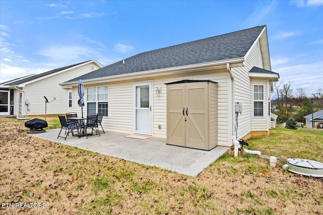 rear view of house featuring a patio area and a yard