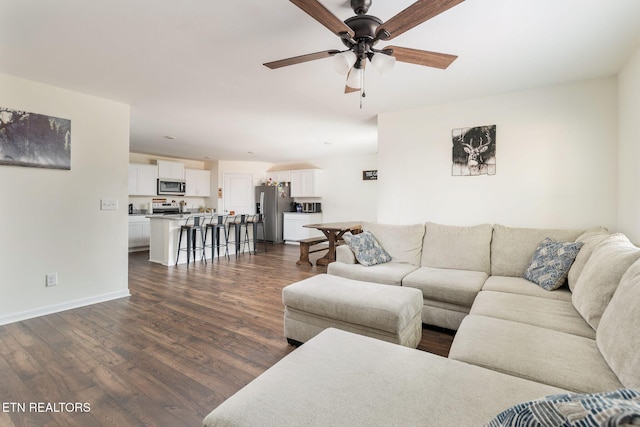 living room with dark hardwood / wood-style flooring and ceiling fan