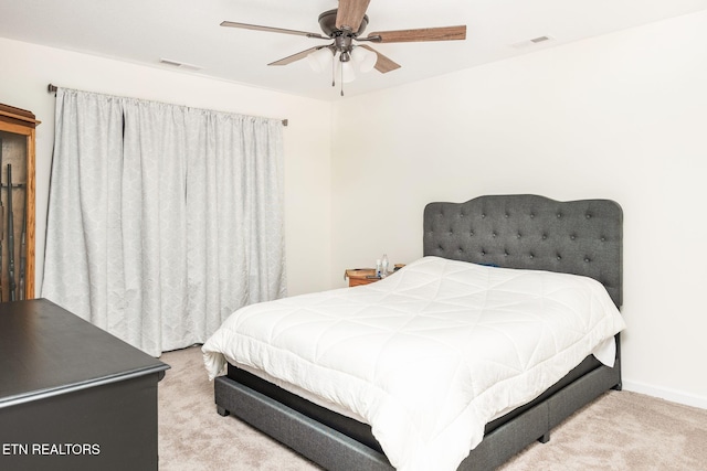 bedroom with ceiling fan and light colored carpet