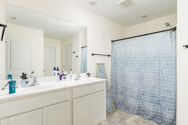 bathroom featuring vanity and curtained shower