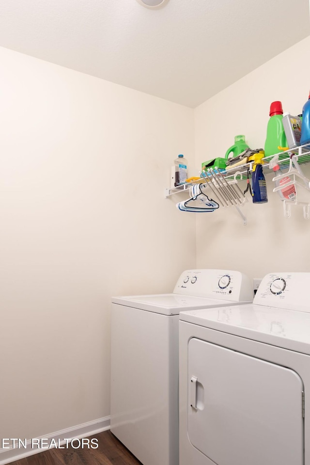 clothes washing area featuring dark hardwood / wood-style flooring and independent washer and dryer