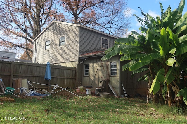 rear view of property featuring a yard