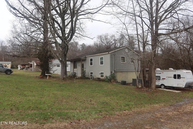 view of property exterior featuring a yard and central AC