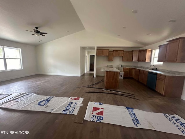 kitchen with a kitchen breakfast bar, ceiling fan, dishwasher, a center island, and lofted ceiling