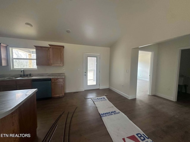 kitchen featuring dark hardwood / wood-style flooring, dishwasher, vaulted ceiling, and sink