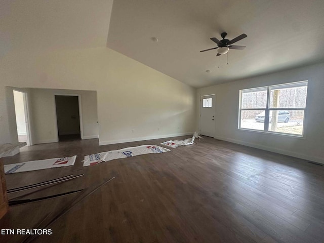 unfurnished living room featuring dark hardwood / wood-style flooring, vaulted ceiling, and ceiling fan