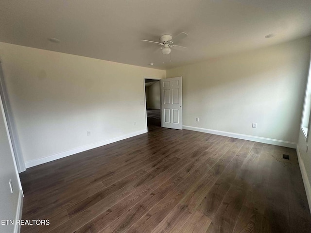 spare room with ceiling fan and dark hardwood / wood-style floors