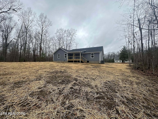 back of house featuring central AC unit