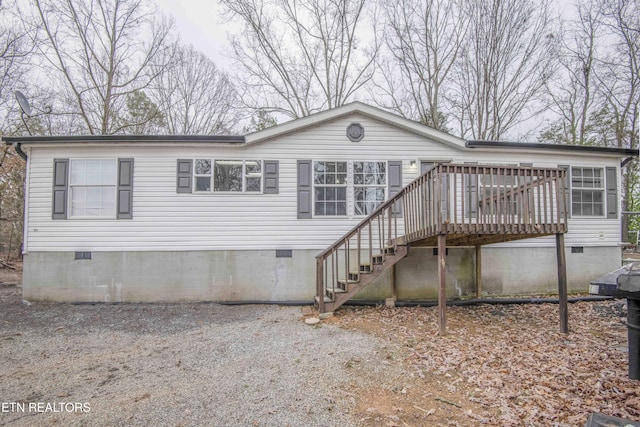 back of house featuring a wooden deck