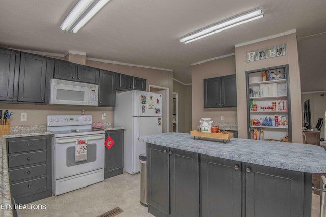 kitchen with a kitchen island, white appliances, ornamental molding, and vaulted ceiling