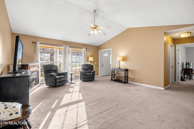 living room featuring light carpet, a textured ceiling, ceiling fan, and lofted ceiling