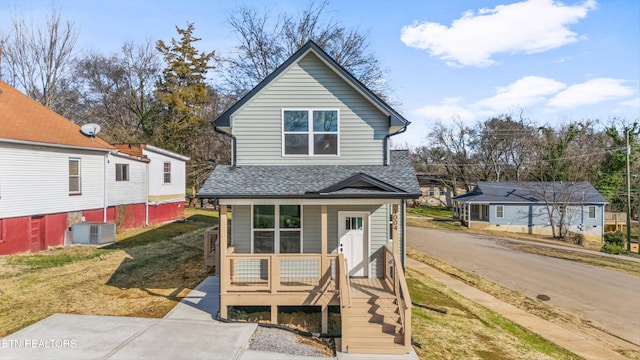 view of property with a porch and central AC unit