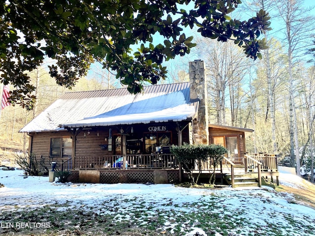 snow covered house with a porch